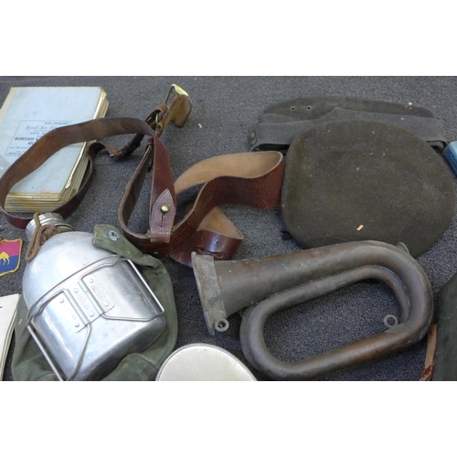 748 - A box of military items; helmet, flask, bugle, paperwork, etc.