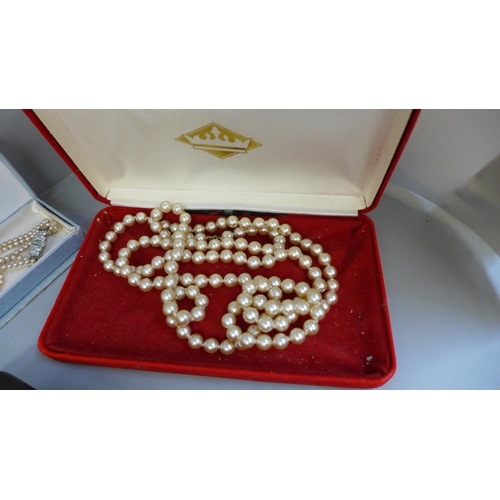 761 - A quantity of faux pearls including Lotus