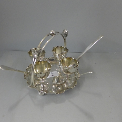 807 - A silver plated four egg cup, spoons and stand