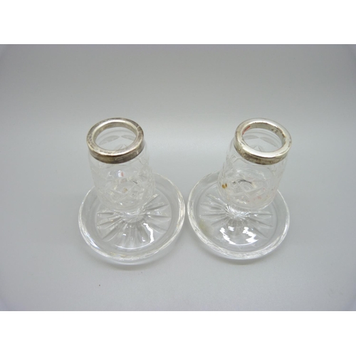 842 - A pair of silver rimmed cut glass candlesticks, 8.5cm