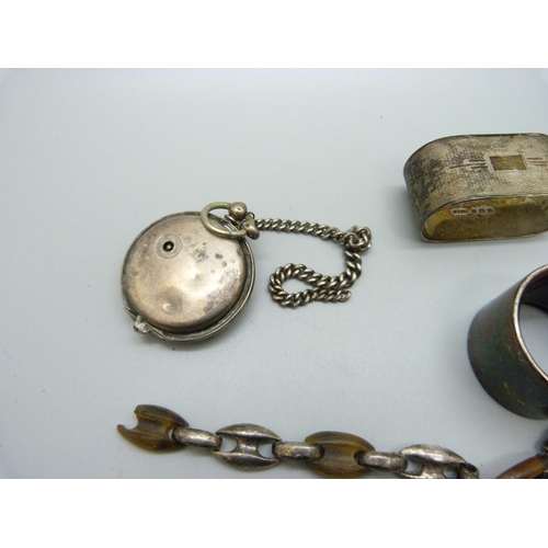 858 - Two silver napkin rings, one lined, a pocket watch, a/f, a silver bracelet, a/f, and two silver meda... 