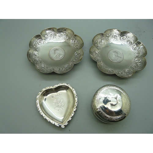 882 - A pair of silver coin set dishes, a Victorian silver heart shaped dish and a circular silver pot wit... 