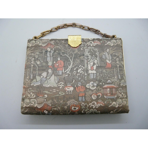 884 - A Japanese purse with silk compartments and metal mount