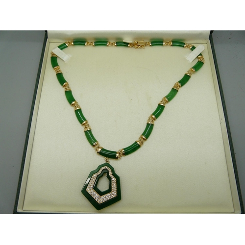 886 - A silver gilt and jade necklace