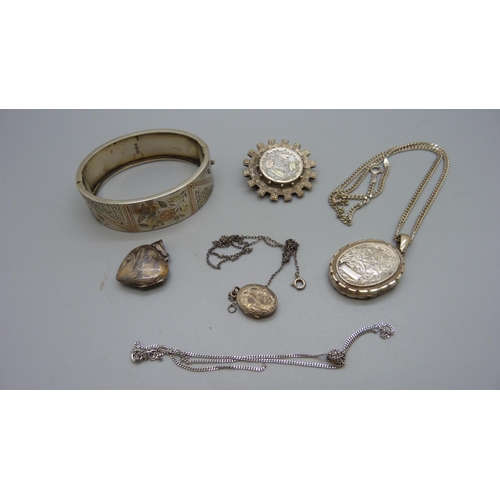 950 - A Victorian silver bangle, Birmingham 1880, a Victorian  brooch and three lockets, (inside of large ... 