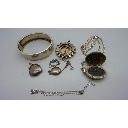 950 - A Victorian silver bangle, Birmingham 1880, a Victorian  brooch and three lockets, (inside of large ... 