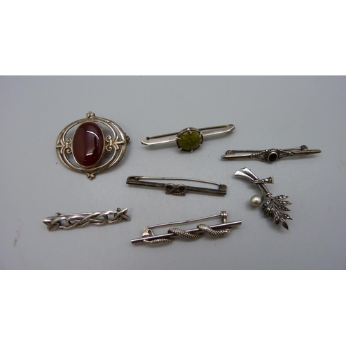 953 - Seven silver brooches including one Scottish set with a red stone and a snake brooch