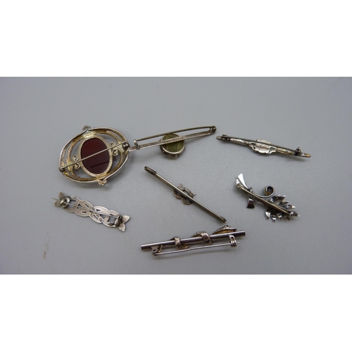 953 - Seven silver brooches including one Scottish set with a red stone and a snake brooch