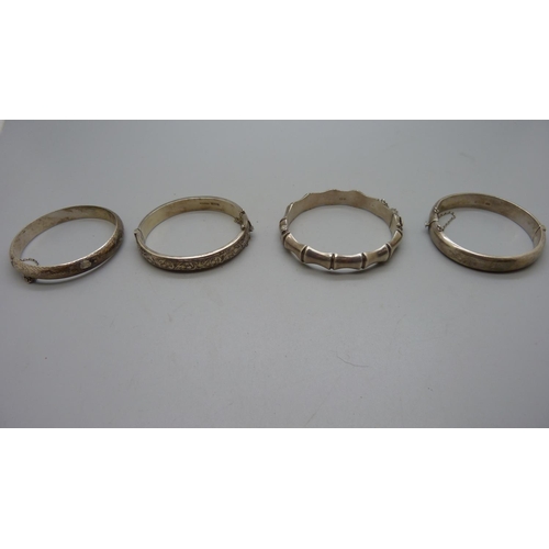 958 - Four silver bangles, 64g