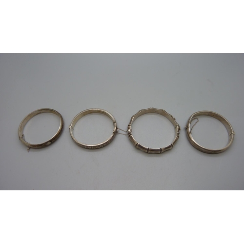 958 - Four silver bangles, 64g