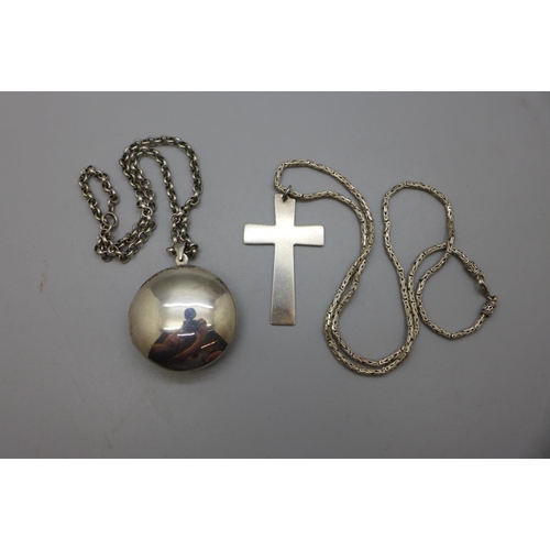 961 - A large silver locket, a silver cross pendant and two silver chins, 70g, cross 36mm x 59mm