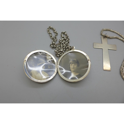 961 - A large silver locket, a silver cross pendant and two silver chins, 70g, cross 36mm x 59mm