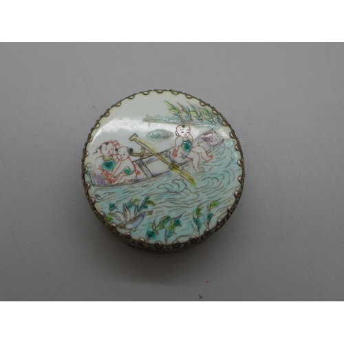 966 - An oriental white metal circular box with river scene, diameter 55mm