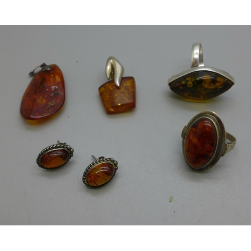 972 - Two silver and amber rings, two silver and amber pendants and a pair of earrings