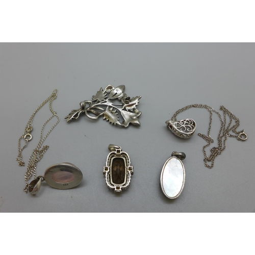 983 - Four silver pendants and a brooch lacking pin