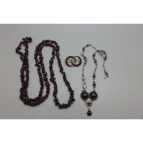 984 - Two garnet necklaces and brooch