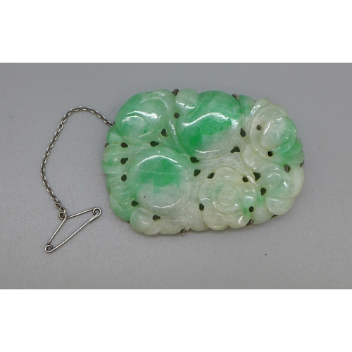 987 - A carved jade brooch set in white metal, 37mm x 50mm