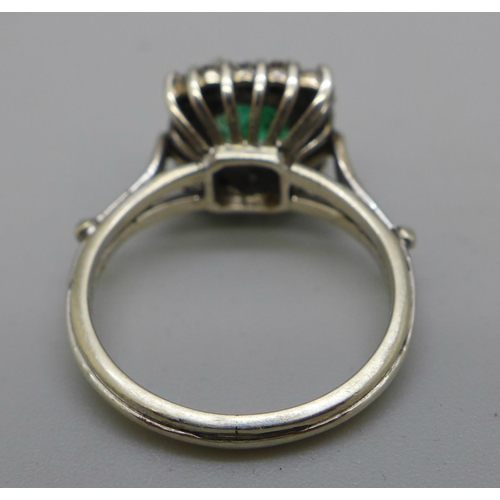 989 - A white metal set, emerald and diamond ring, 3.5g, M