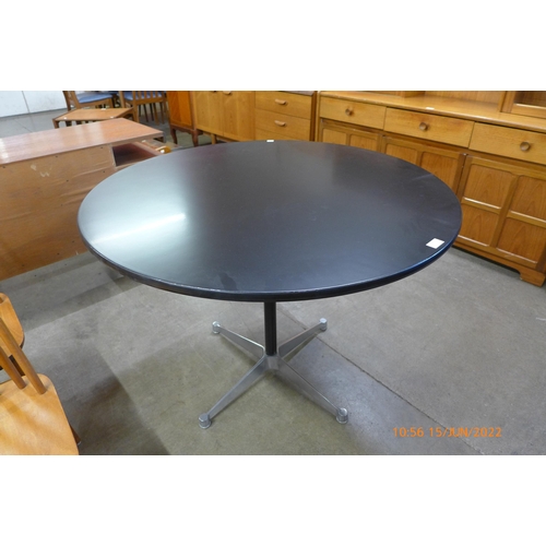 73 - An Eames style circular black and steel based kitchen table