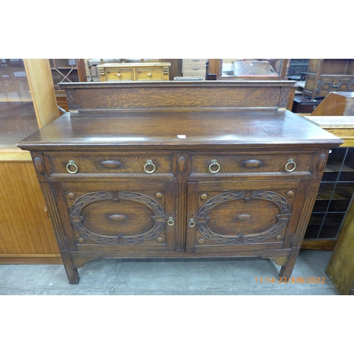 117 - An early 20th century carved oak sideboard