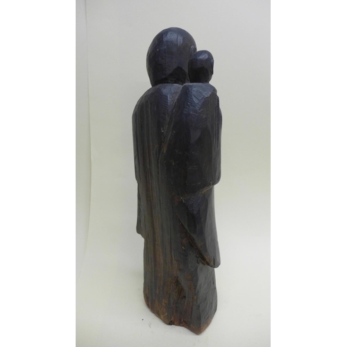 792 - A late 19th century/early 20th century carved wooden figure of a monk and young monk 36cm