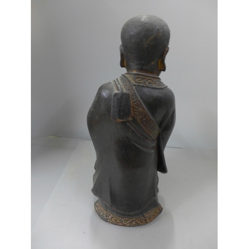 794 - A 19th Century carved wooden polychrome figure of a young monk, base split, 32cm