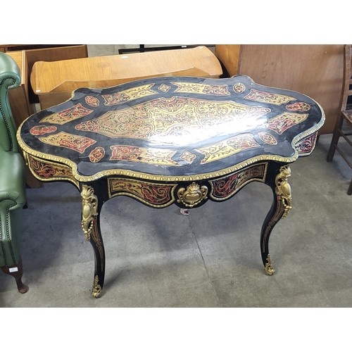 163 - A French style ebonised, brass and faux tortoiseshell bureau plat