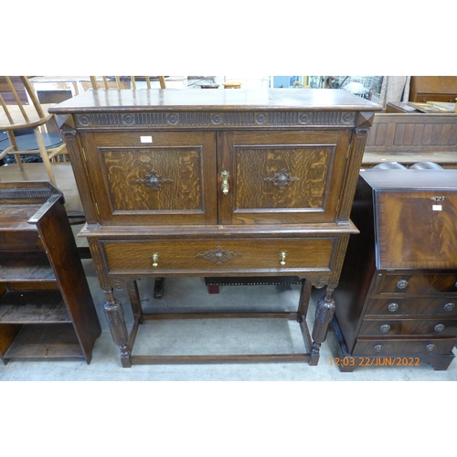 177 - A carved oak side cabinet