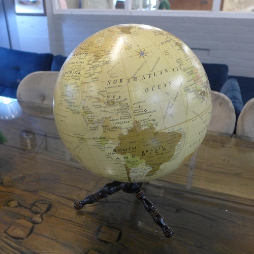 1332 - A large terrestrial globe on a wooden stand