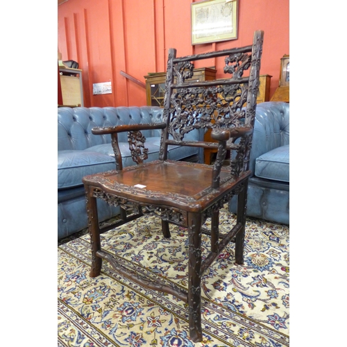 1 - A late 19th/early 20th Century Chinese carved padouk wood elbow chair