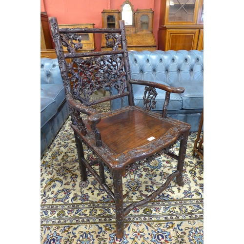 1 - A late 19th/early 20th Century Chinese carved padouk wood elbow chair