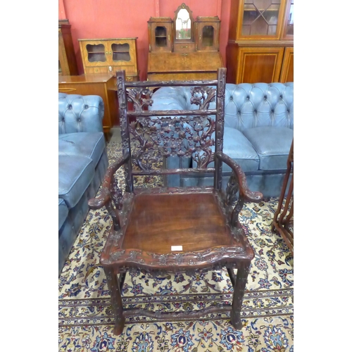 1 - A late 19th/early 20th Century Chinese carved padouk wood elbow chair