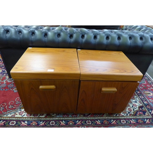 104 - A pair of simulated teak bedside tables