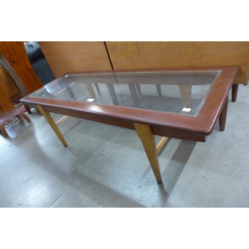 105 - A teak and glass topped coffee table