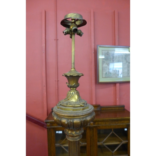 11 - An Italian carved giltwood floor standing downlighter lamp