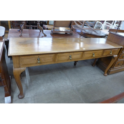 110 - A large early 20th Century oak four drawer serving table