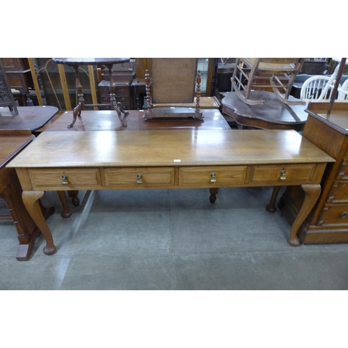 110 - A large early 20th Century oak four drawer serving table