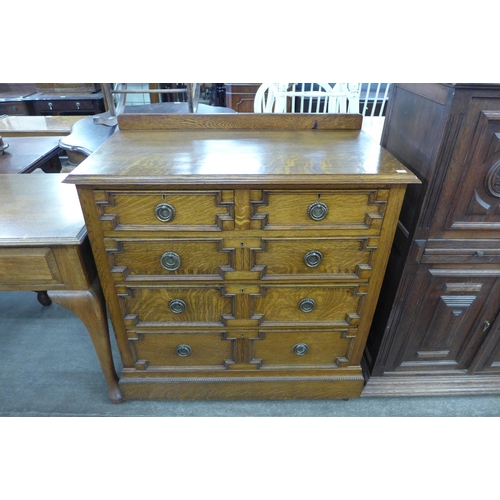 111 - An early 20th Century oak geometric moulded chest of drawers