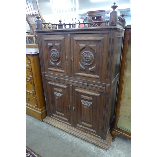 113 - A 19th Century French Breton carved oak four door housekeepers cupboard