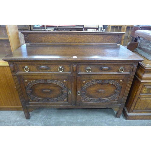 117 - An early 20th century carved oak sideboard