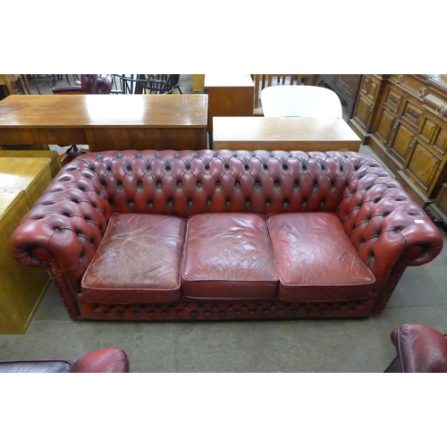 126 - A red leather Chesterfield settee