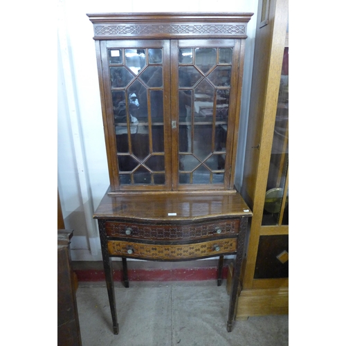 131 - An Edward VII Chippendale Revival mahogany side cabinet, with carved blind fret decoration