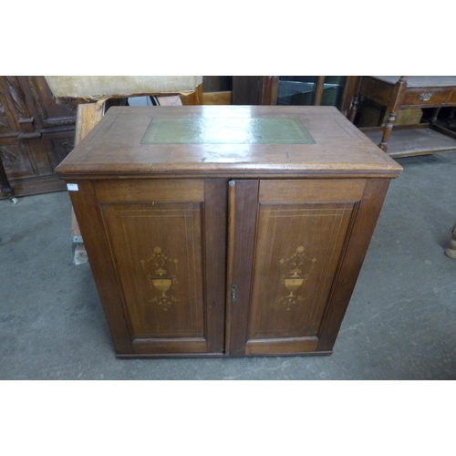 134 - An Edward VII inlaid mahogany fitted two door cupboard