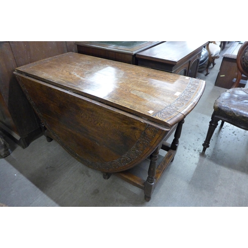 137 - A carved oak gateleg table