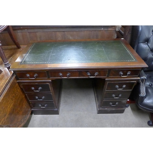 139 - A mahogany and green leather topped pedestal desk