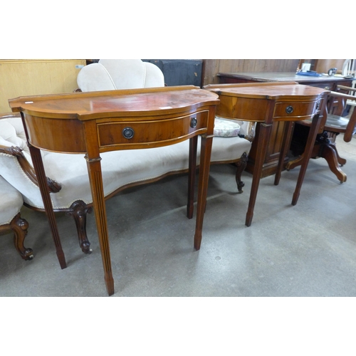 142 - A pair of yew wood single drawer console tables