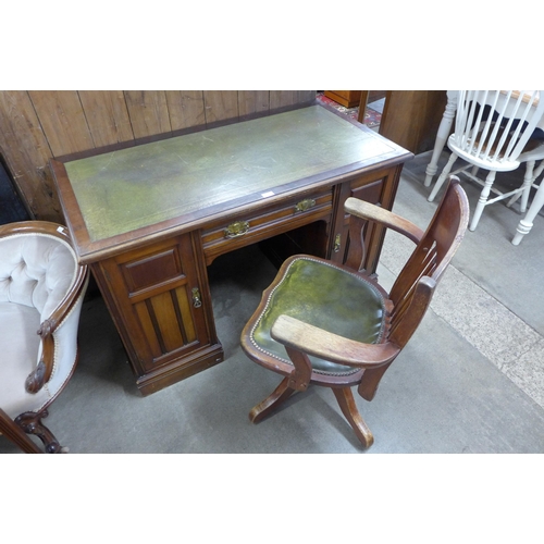 144 - An Edward VII mahogany and green leather topped desk and an oak revolving desk chair