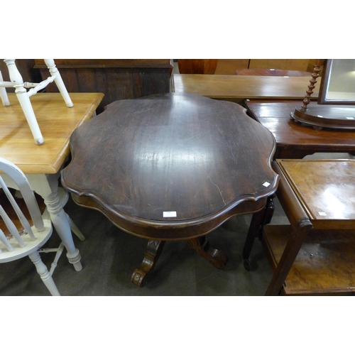 148 - A Victorian rosewood serpentine breakfast table