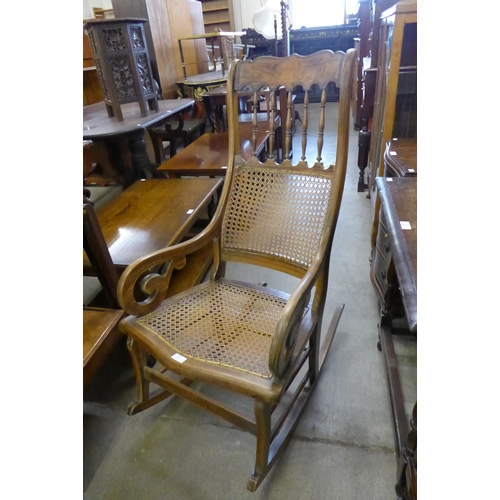 149 - A French beech and yew wood bergere rocking chair