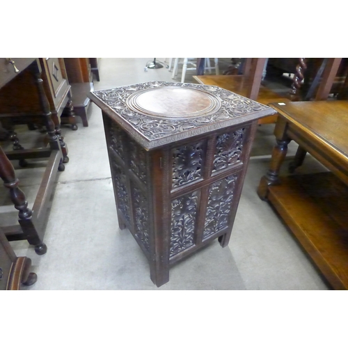 154 - An Indian carved wood corner occasional table